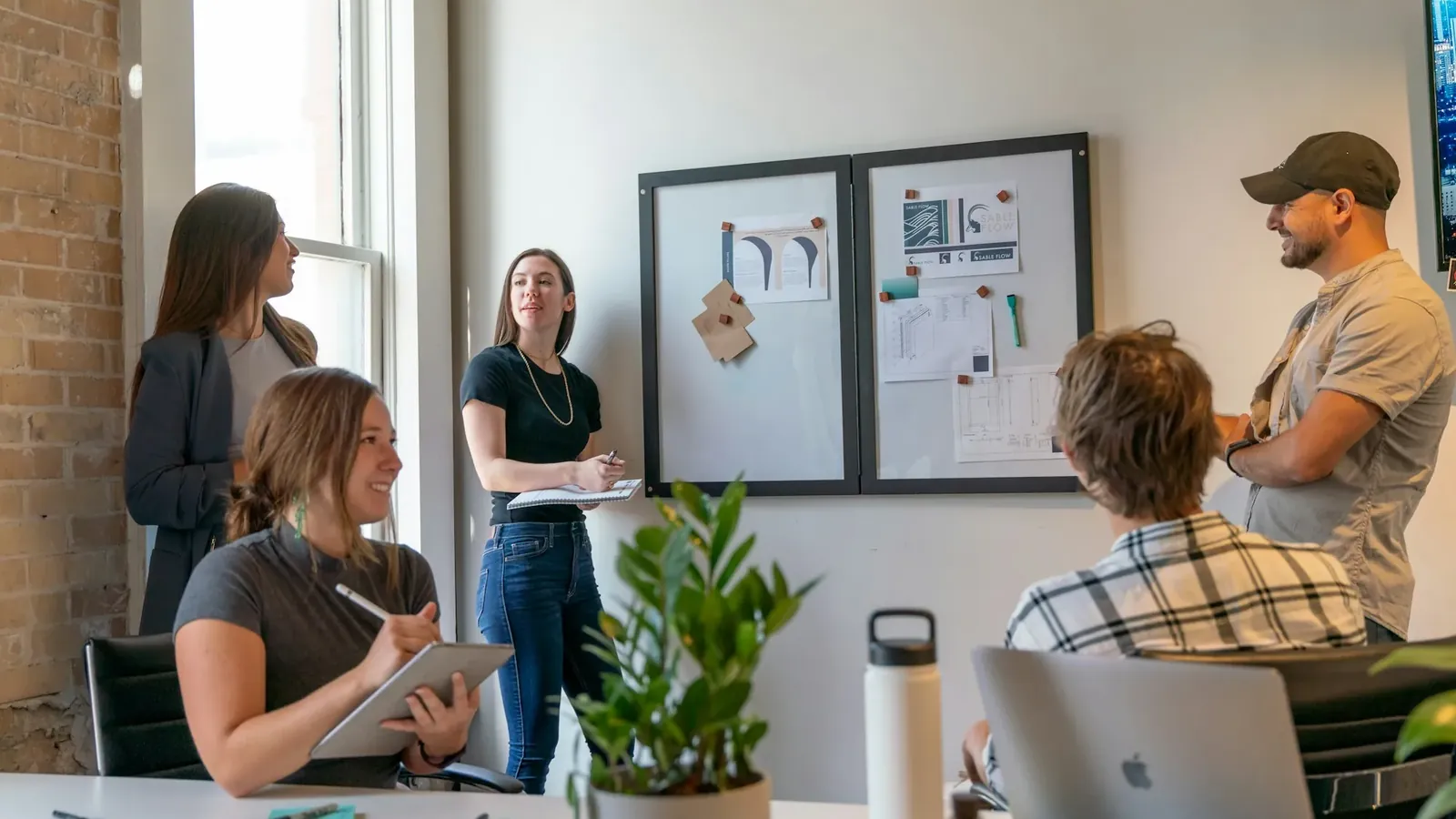 A small team working through a problem around a table.